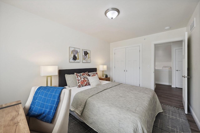 bedroom featuring dark wood-type flooring and a closet