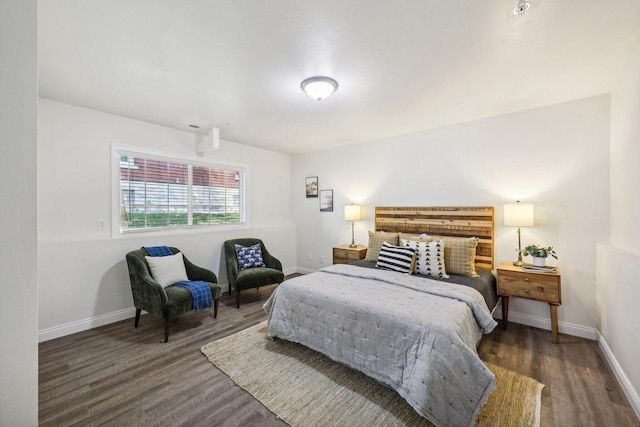 bedroom with dark hardwood / wood-style flooring