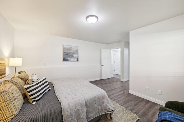 bedroom with dark hardwood / wood-style flooring