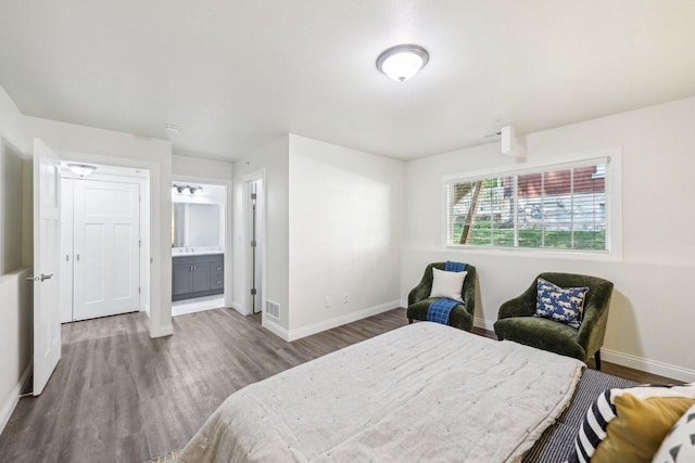 bedroom featuring hardwood / wood-style floors and ensuite bath