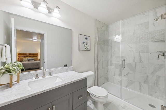 bathroom with toilet, vanity, and a shower with shower door