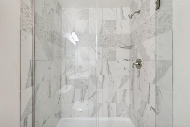 bathroom with tiled shower