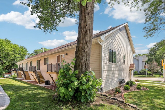 view of side of home with a lawn