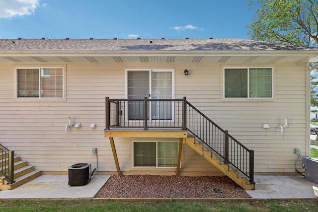 rear view of house with a patio and cooling unit