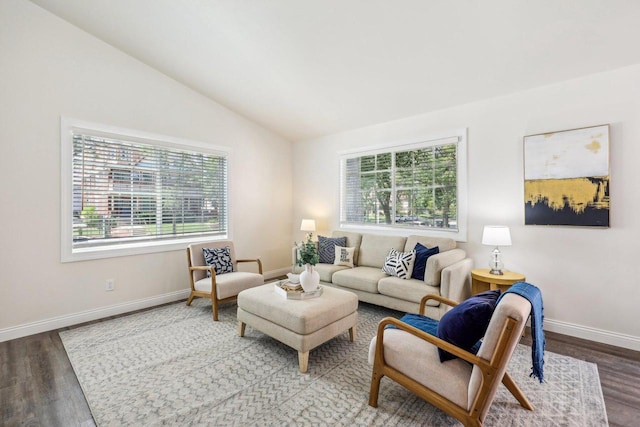 living room featuring a wealth of natural light, vaulted ceiling, and hardwood / wood-style flooring