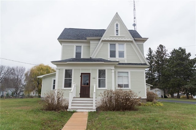 victorian-style house featuring a front lawn