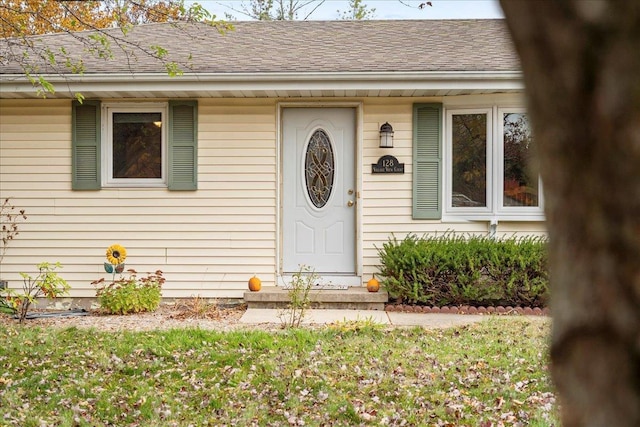 entrance to property with a lawn