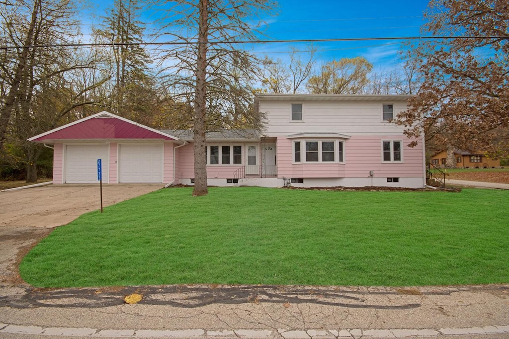 front of property featuring a garage and a front yard