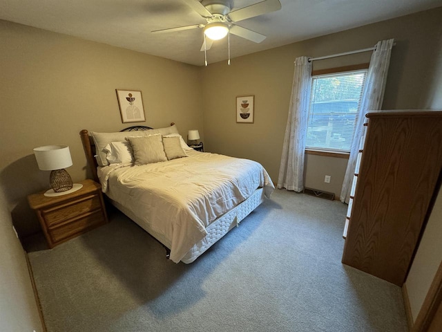 bedroom featuring light colored carpet and ceiling fan