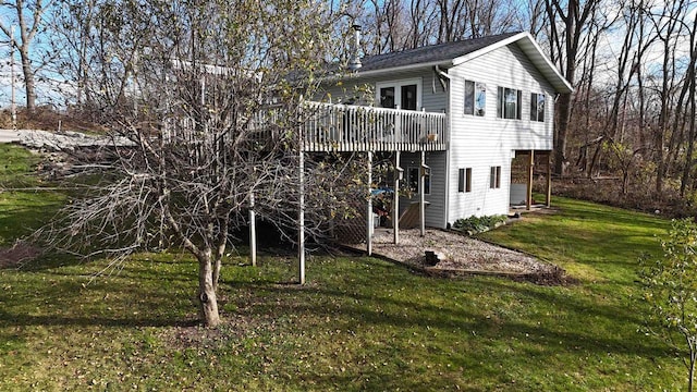 back of property with a lawn and a wooden deck