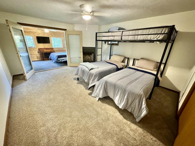 carpeted bedroom featuring ceiling fan and access to exterior