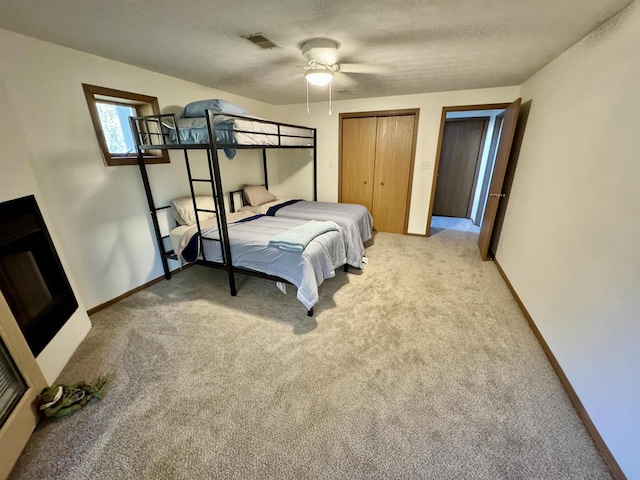 bedroom featuring ceiling fan, multiple closets, and carpet floors