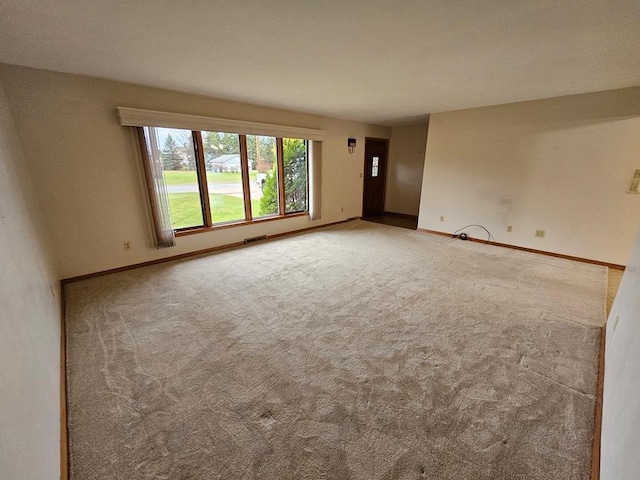 unfurnished room featuring carpet