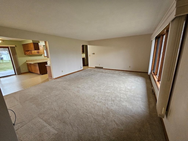 unfurnished living room featuring light carpet