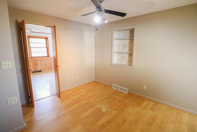 empty room with light wood-type flooring and ceiling fan