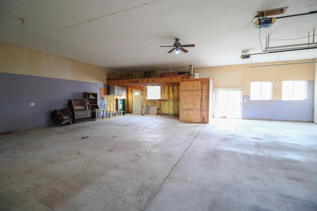 garage with a garage door opener and ceiling fan