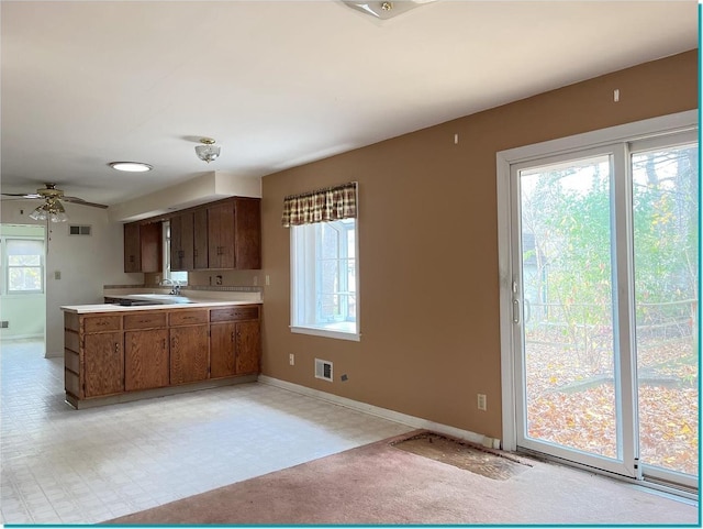 kitchen featuring ceiling fan, a healthy amount of sunlight, and sink