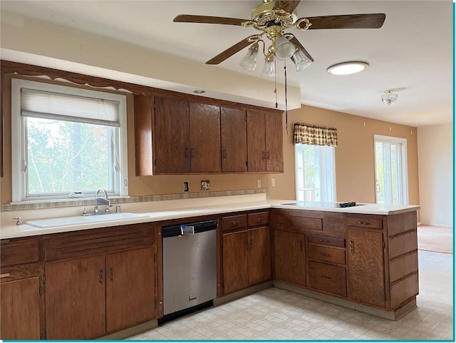 kitchen with kitchen peninsula, sink, stainless steel dishwasher, ceiling fan, and stovetop