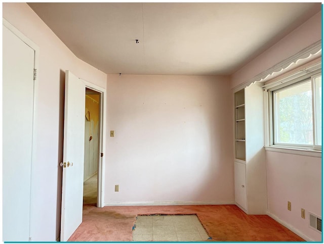 unfurnished room with light colored carpet