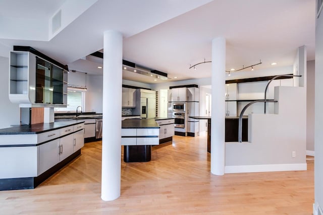 kitchen with light hardwood / wood-style flooring, a center island, and appliances with stainless steel finishes