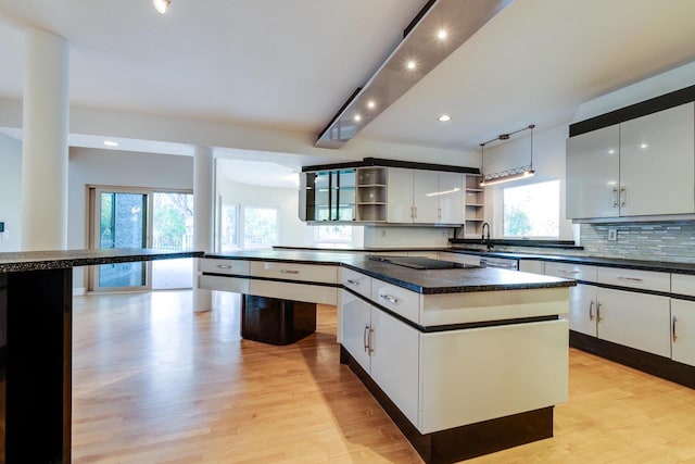 kitchen featuring a wealth of natural light and white cabinets