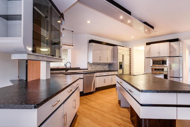 4720 Sumac Rd, Middleton, WI 53562 - kitchen featuring built in appliances, dark countertops, tasteful backsplash, recessed lighting, and white cabinetry
