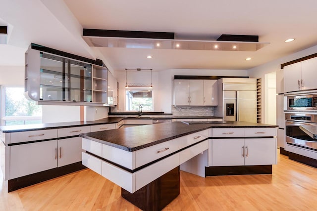 4720 Sumac Rd, Middleton, WI 53562 - kitchen with built in appliances, a kitchen island, dark countertops, beam ceiling, and recessed lighting