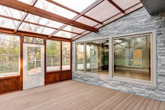 unfurnished sunroom featuring vaulted ceiling with beams