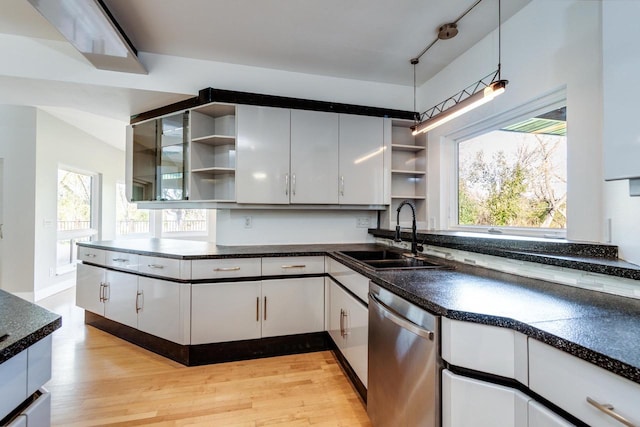 kitchen featuring white cabinetry, dishwasher, sink, pendant lighting, and light hardwood / wood-style floors