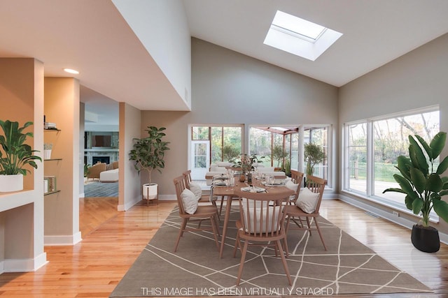 4720 Sumac Rd, Middleton, WI 53562 - dining space featuring high vaulted ceiling, a skylight, light wood-style flooring, plenty of natural light, and recessed lighting