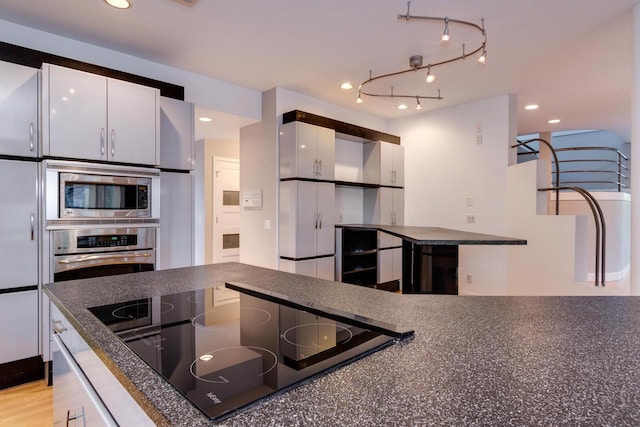 4720 Sumac Rd, Middleton, WI 53562 - kitchen featuring appliances with stainless steel finishes, dark countertops, white cabinets, beverage cooler, and recessed lighting