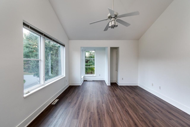 spare room featuring dark hardwood / wood-style flooring, a wealth of natural light, lofted ceiling, and ceiling fan