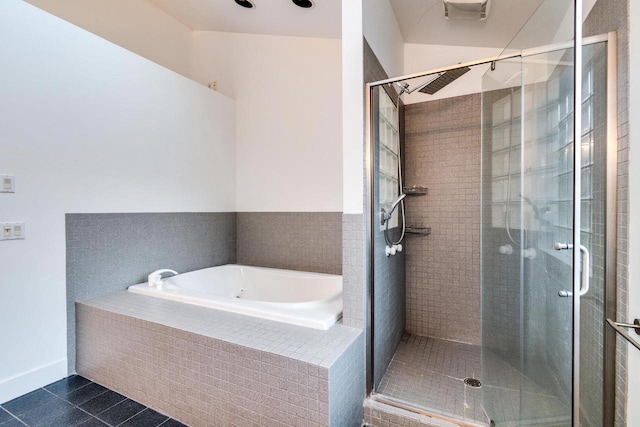 bathroom featuring plus walk in shower and tile patterned flooring