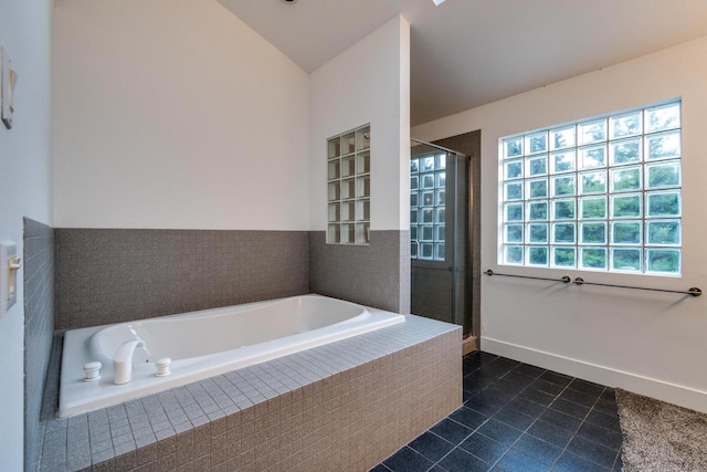 bathroom featuring vaulted ceiling, independent shower and bath, and tile patterned flooring