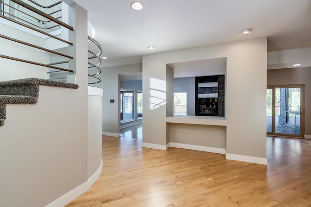 hallway with hardwood / wood-style flooring and a notable chandelier