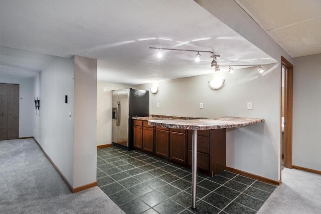 kitchen with dark carpet and stainless steel refrigerator with ice dispenser