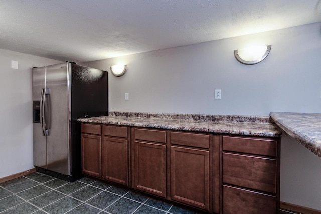 bathroom featuring tile patterned floors, vanity, and a textured ceiling