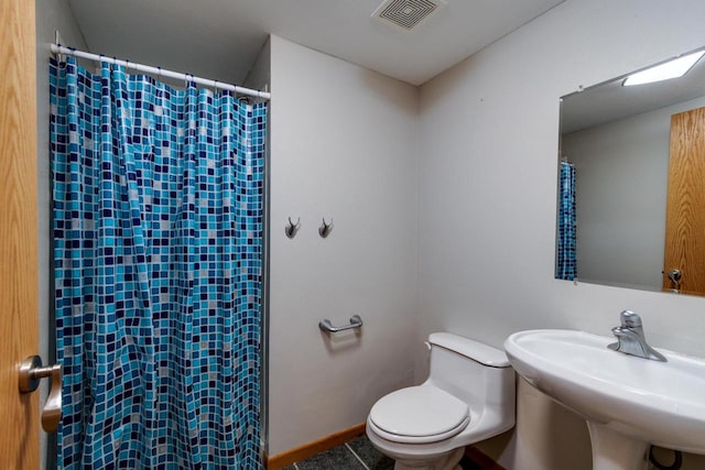 bathroom featuring toilet and sink