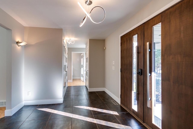 tiled foyer featuring a wealth of natural light