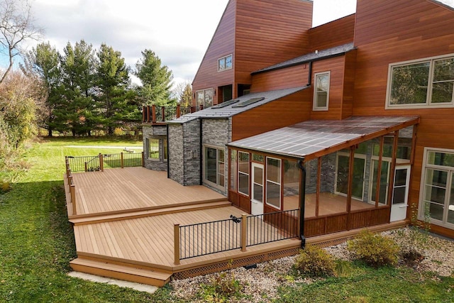 wooden terrace with a yard and a sunroom