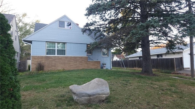 view of side of property with a lawn