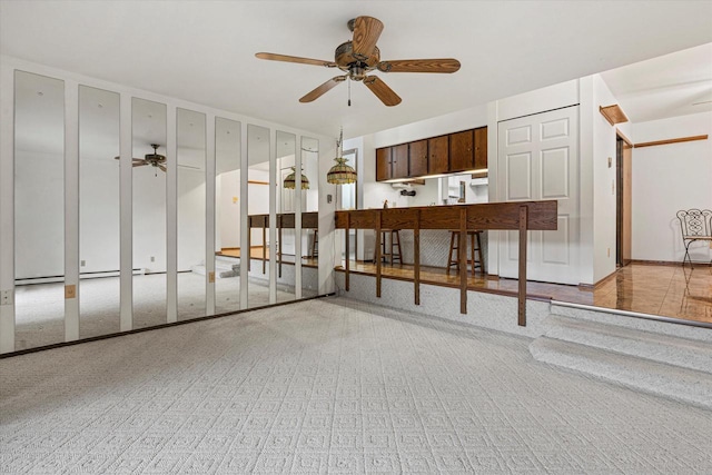 interior space with light colored carpet and ceiling fan