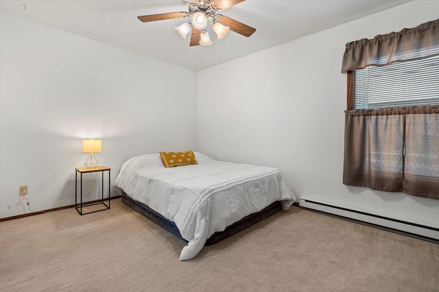 carpeted bedroom with baseboard heating and ceiling fan