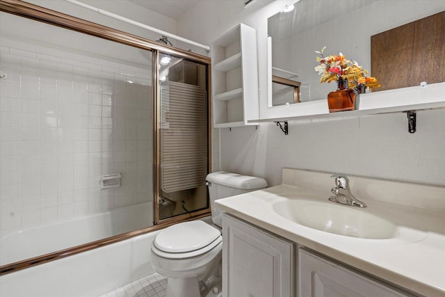 full bathroom featuring tile patterned floors, vanity, toilet, and enclosed tub / shower combo