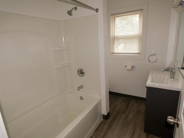 bathroom featuring hardwood / wood-style floors, vanity, and bathtub / shower combination