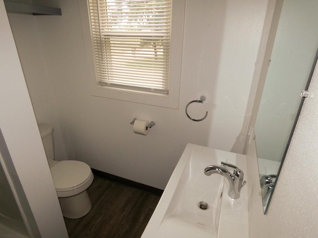 bathroom featuring hardwood / wood-style floors and toilet