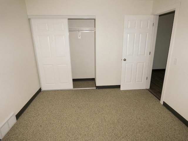 unfurnished bedroom with carpet and a closet