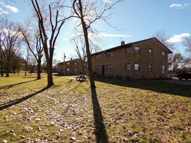 view of side of home featuring a yard