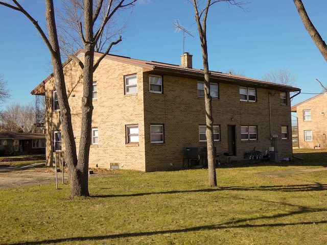 rear view of property with a yard