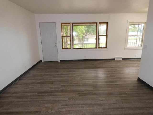 empty room with dark wood-type flooring